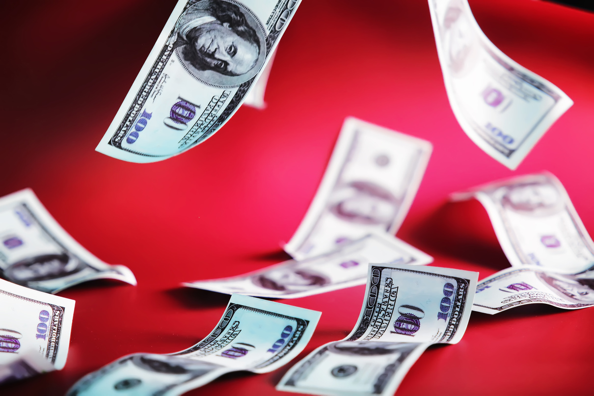 Green Dollar Bills on a Red Background. 100 Dollar Bills Close U